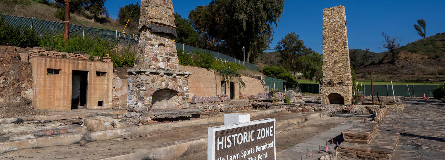 Post-fire view of Will Rogers' ranch house, with only stone fireplaces, chimneys, and floor remaining. 
